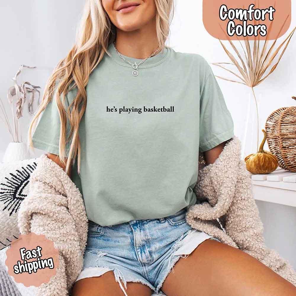 He’s Playing Basketball – Funny Sports Girlfriend Comfort Color Shirt for Women